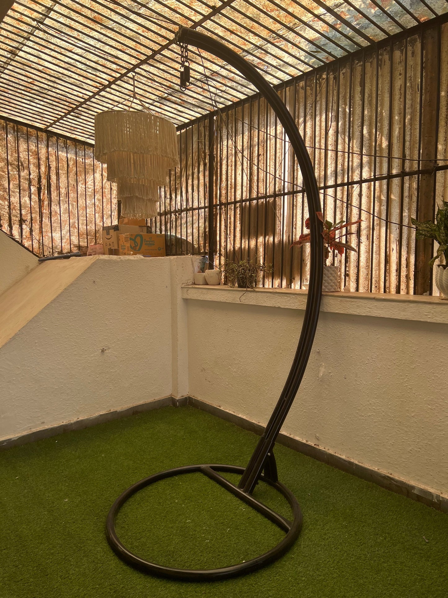 black metal stand on a faux grass mat.