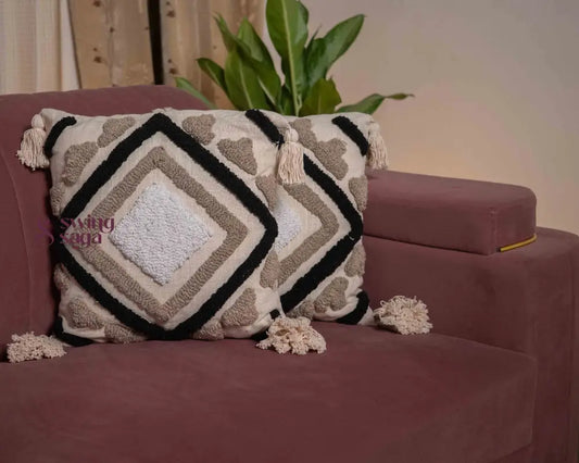 pair of square sofa cushions in white color with black tufted print.