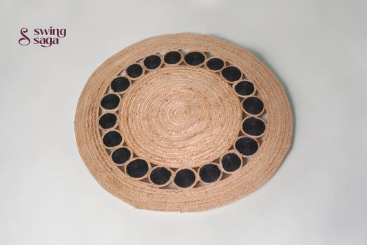 Round woven placemat with black circular patterns on a light gray background