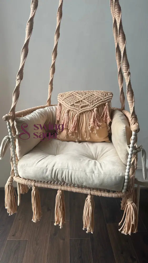 Cozy and handcrafted coral macrame swing chair for indoor and balcony use. Holds 100 kg. Perfect for reading nooks and relaxing corners.