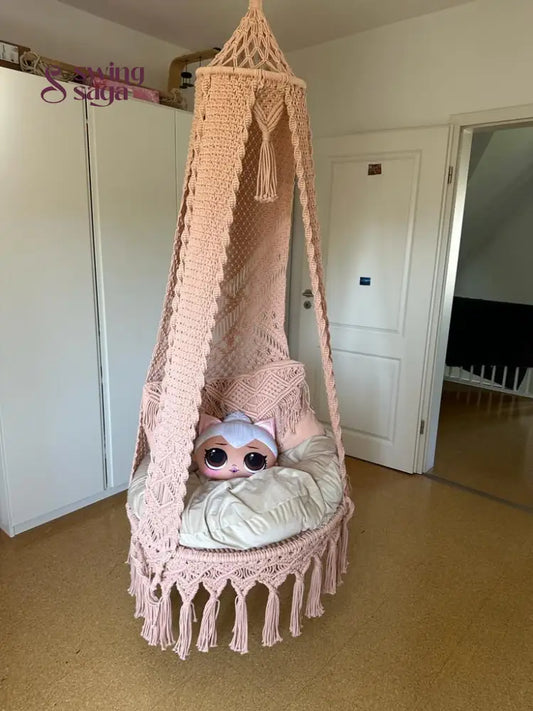 Macrame seater swing with two square shaped macrame cushions and one cartoon face cushion.