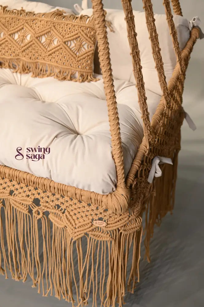 Brown macrame swing with white cushion