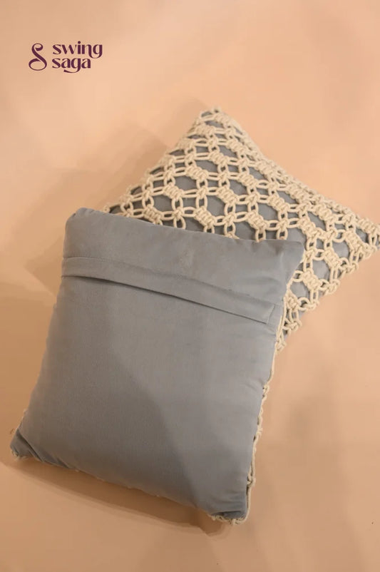 Gray pillow with lace trim on a beige background
