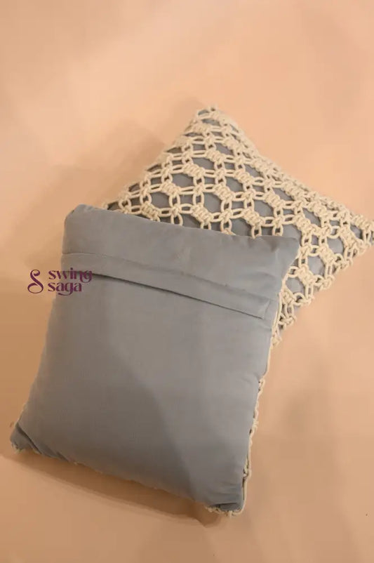 Gray pillow with lace trim on a beige background