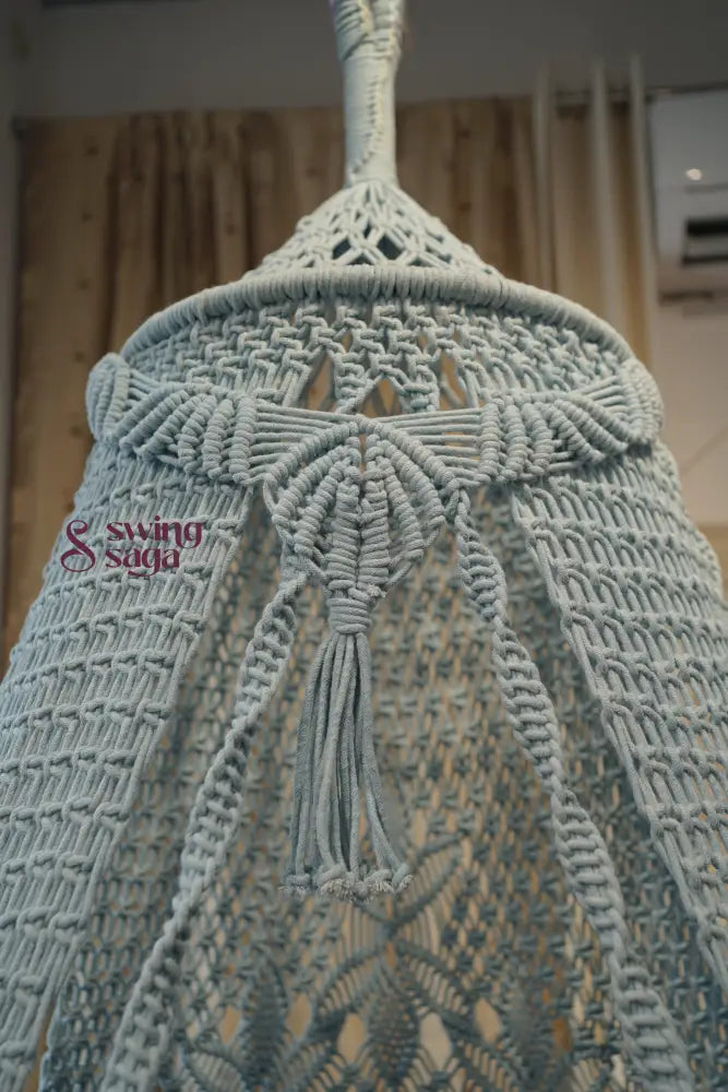 Close-up of a textured fabric with tassels on a blurred background