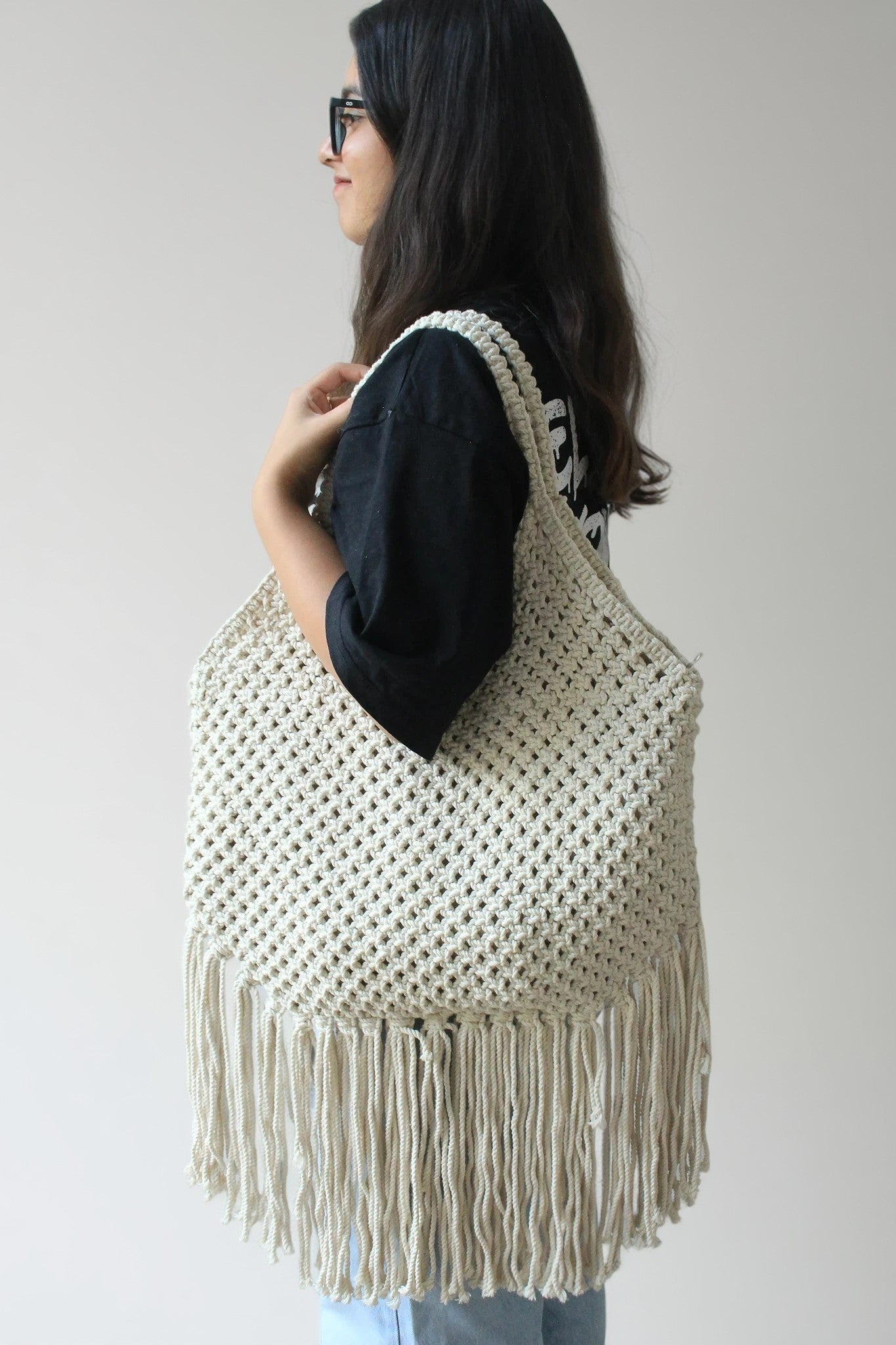 women carrying handcrafted fringe tote shoulder bag with long fringes for everyday use.