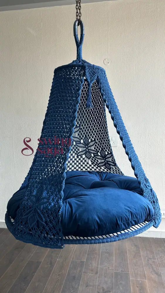 Angled view of handcrafted royal blue macrame swing with spacious seating for two.