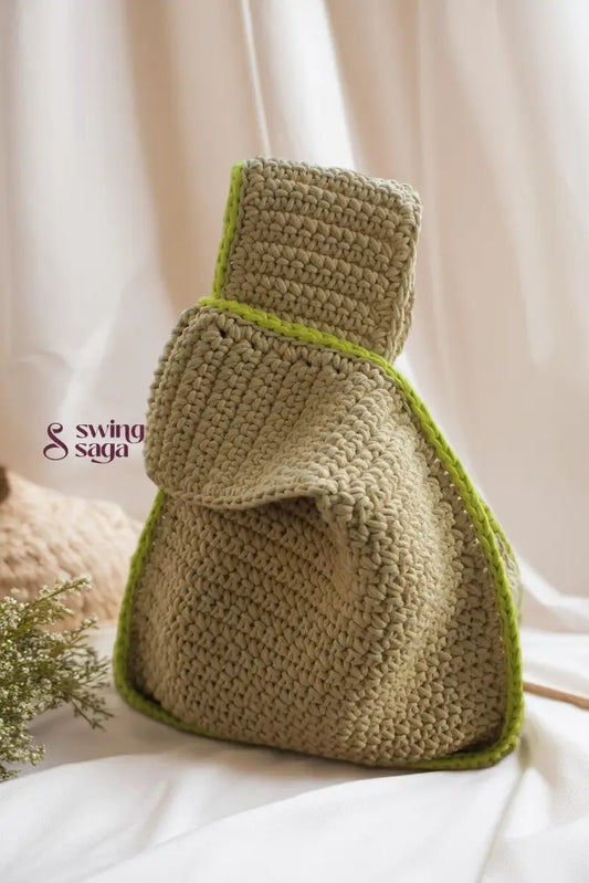 handcrafted beige crochet handbag with green lining on the corner for everyday use.