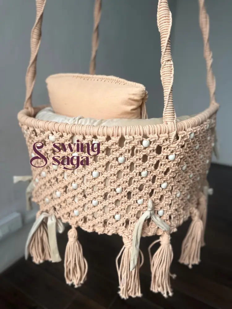 Back view of Coral Hug macrame swing chair showing detailed handwoven macrame with tassels and white beads.