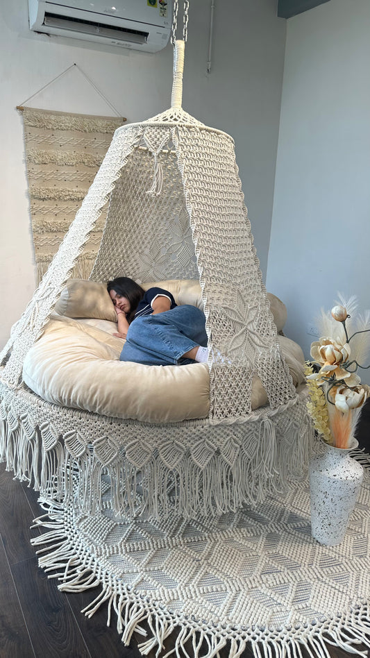 photo of a girl sleeping on a bed swing in an aesthetic decor.