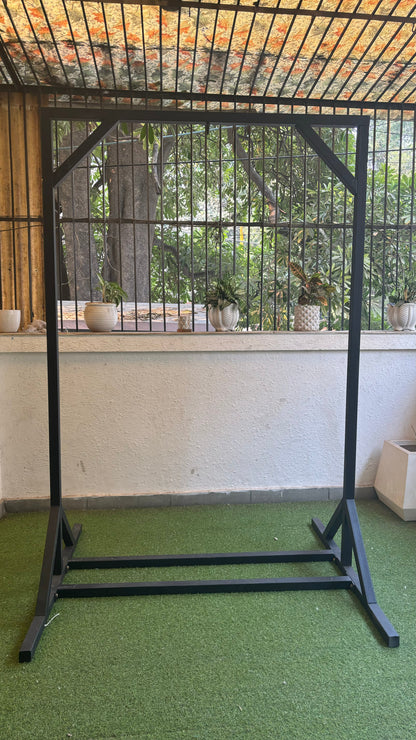 black metal stand on a faux grass mat.