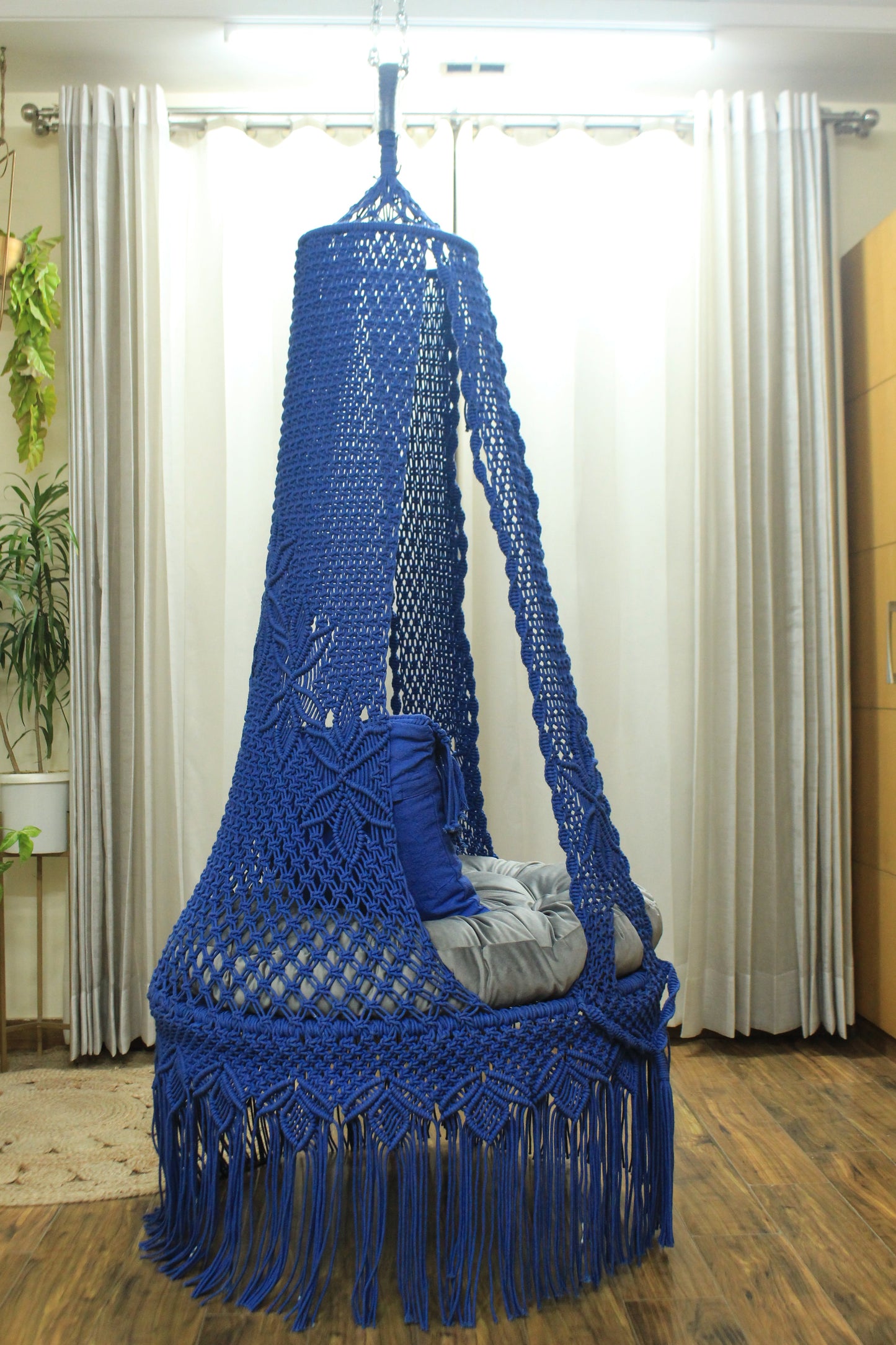 macrame hanging chair swing in blue color.