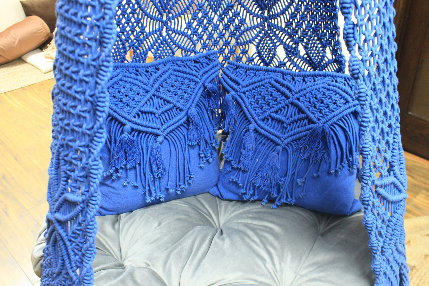 Close up of a macrame swing in blue color.