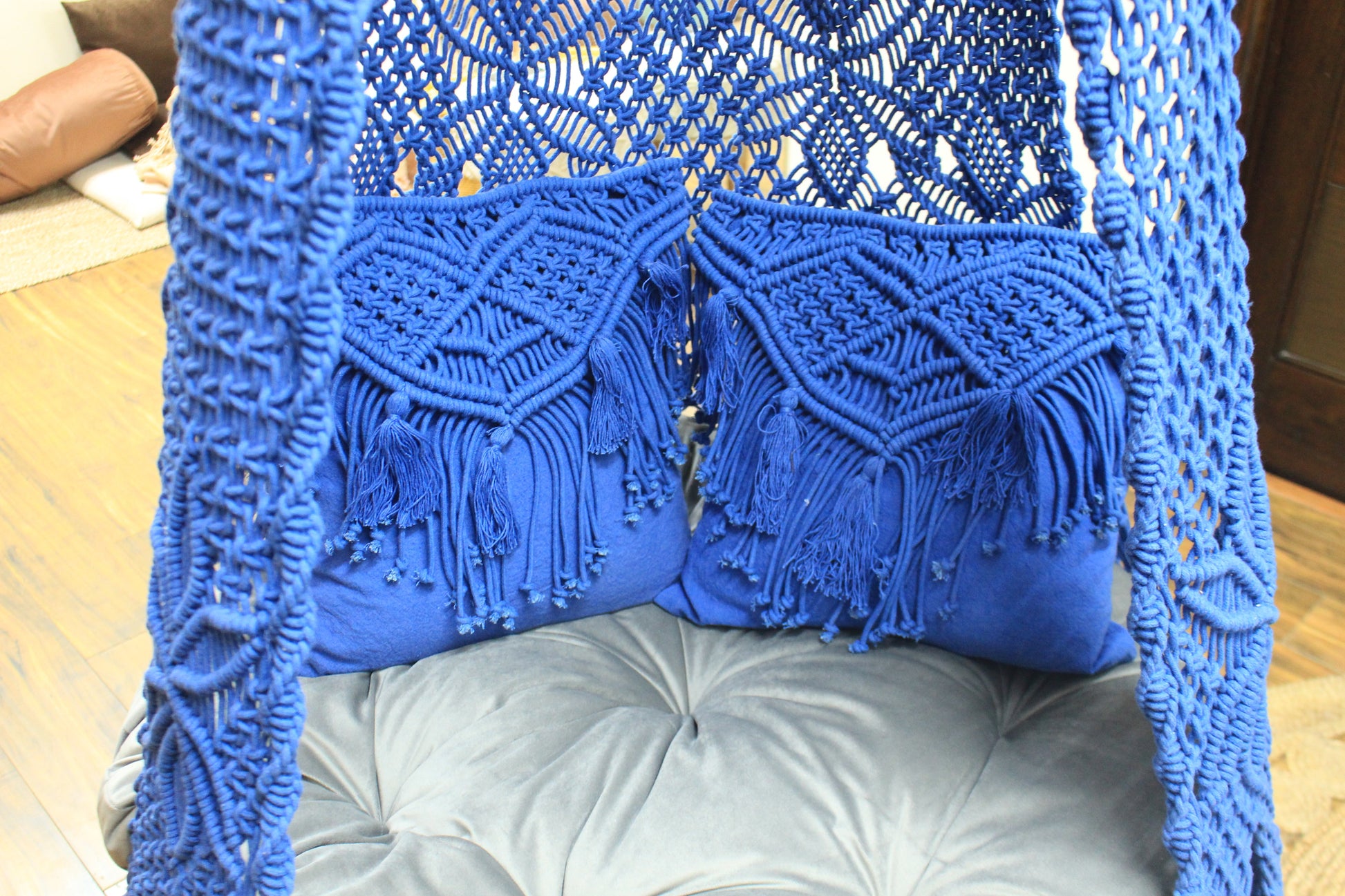 Close up of a macrame swing in blue color.