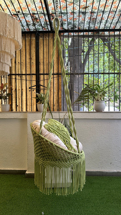 Handcrafted macrame chair hammock hanging swing in green color.