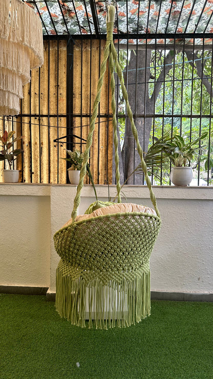 Handcrafted macrame chair  hanging swing in green color.