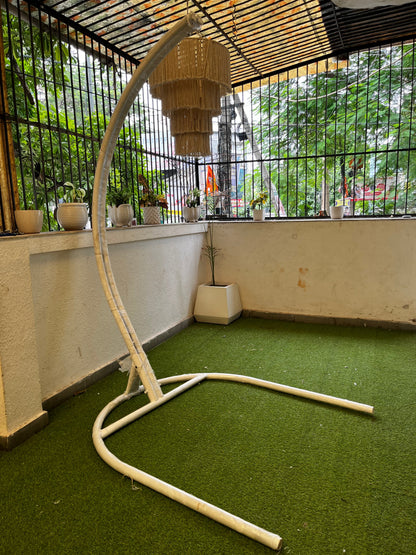  Metal white stand with curved arm on a faux grass