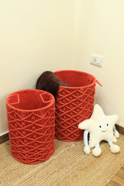 Pair of red handcrated macrame laundry baskets with a smiley face star cushion.