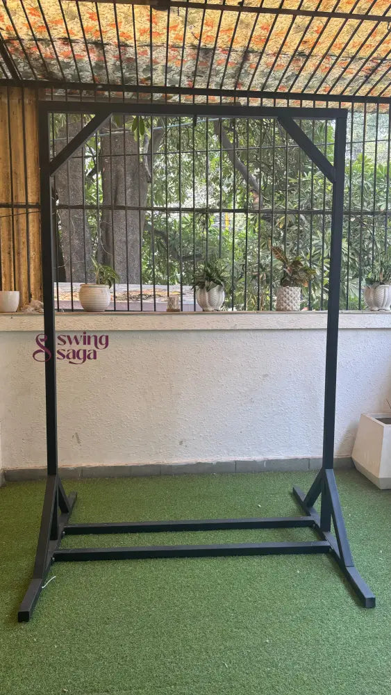 Black metal stand on a faux grass mat