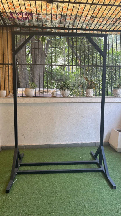 Black metal stand on a faux grass mat