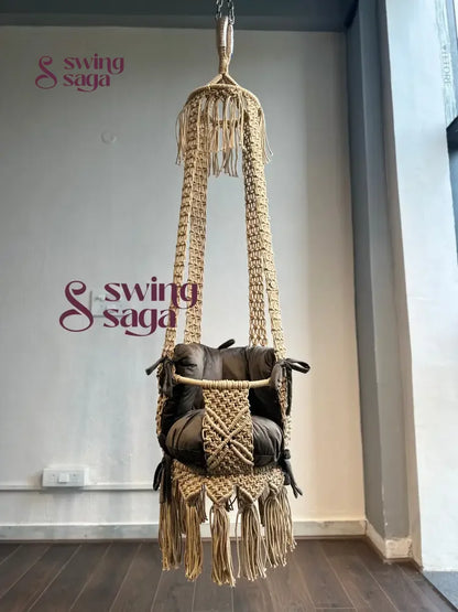 beige color baby swing front view with dark brown color mattress and backrest.