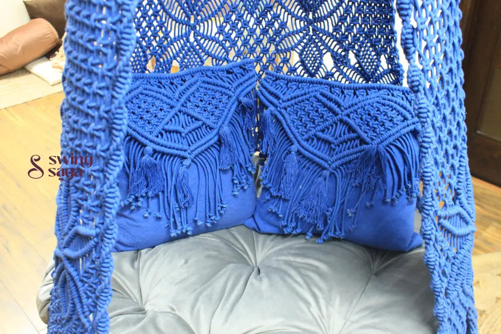 Close up of a macrame swing in blue color.