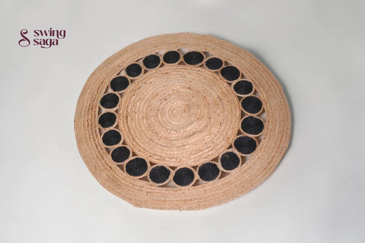 Round woven placemat with black circular patterns on a light gray background