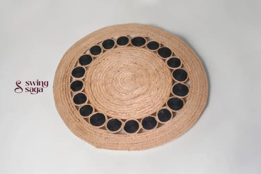 Round woven placemat with black circular patterns on a light gray background