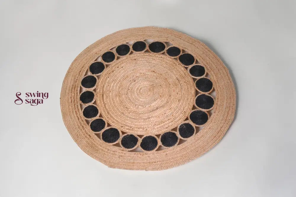 Round woven placemat with black circular patterns on a light gray background
