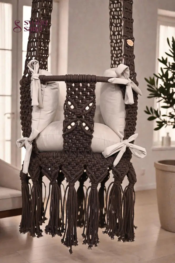 Macrame Baby Swing with cushions in a room setting