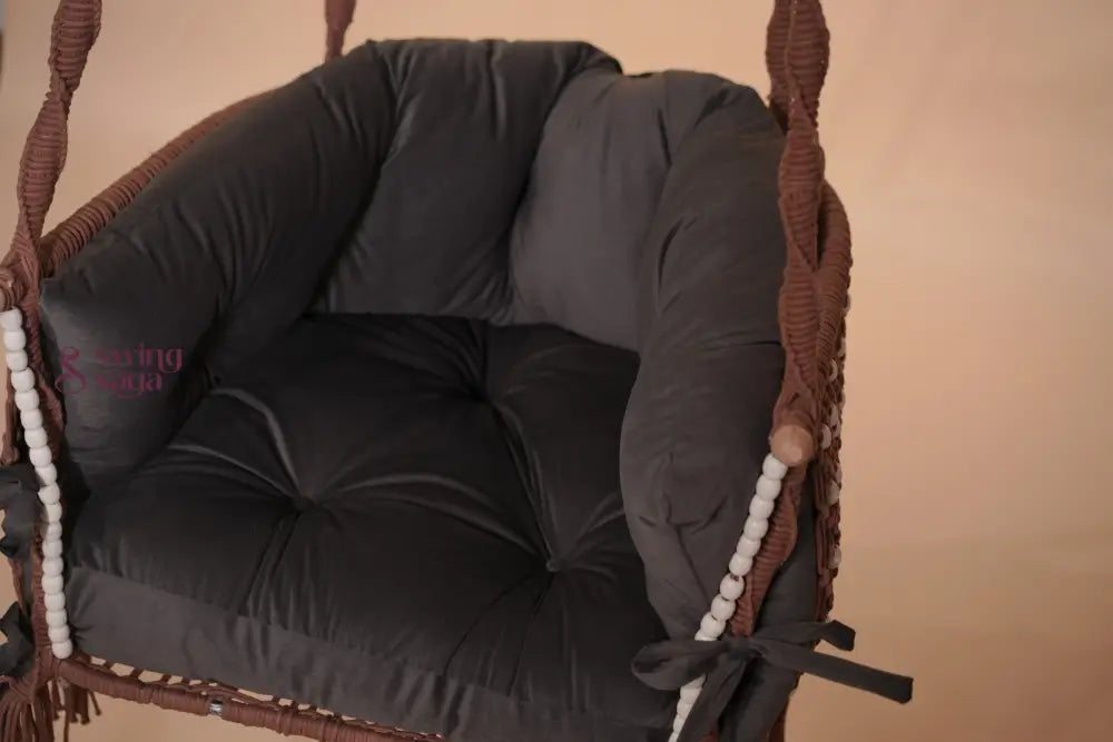 Wicker chair with dark cushion on a beige background
