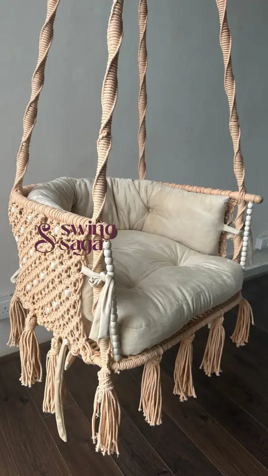 Handcrafted coral macrame swing chair with tassels and cushion – cotton hanging swing for balcony and indoor seating

