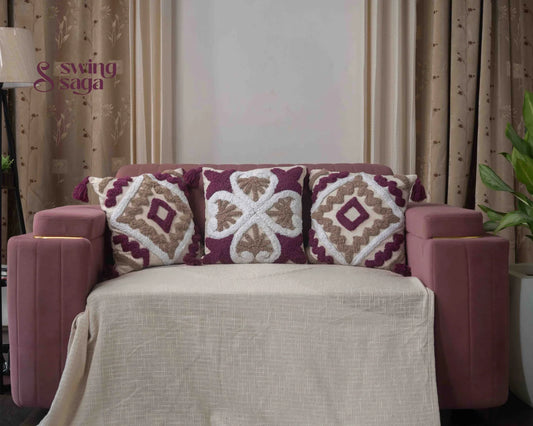 Cream and maroon patterned cushion with decorative fabric design.