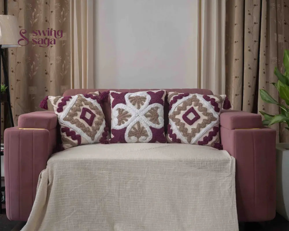 Cream and maroon patterned cushion with decorative fabric design.