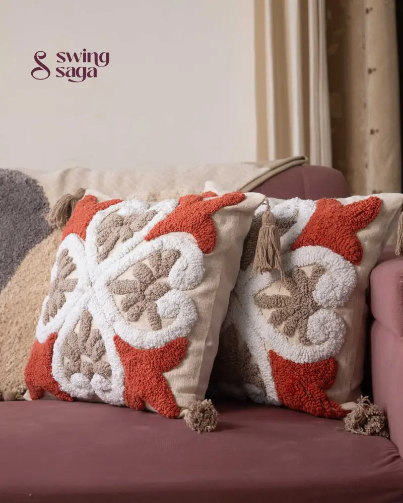 Cream and orange Tufted Pillow  in square shape.