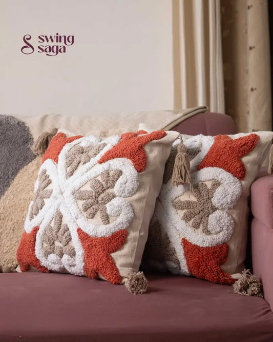 Cream and orange Tufted Pillow  in square shape.