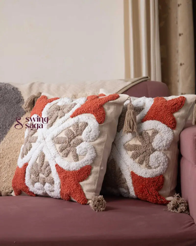 Cream and orange Tufted Pillow  in square shape.