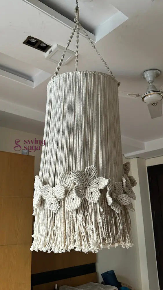 Cream macrame chandelier with floral accents and top ring hanger