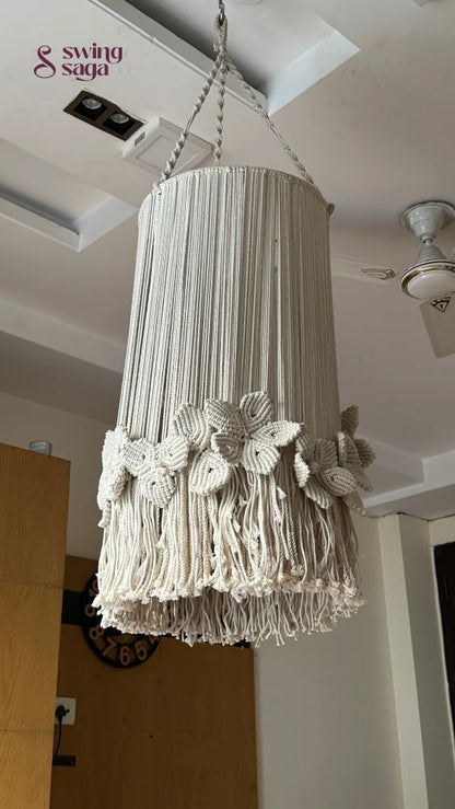 Decorative macrame cream chandelier with floral accents and circular hanging frame
