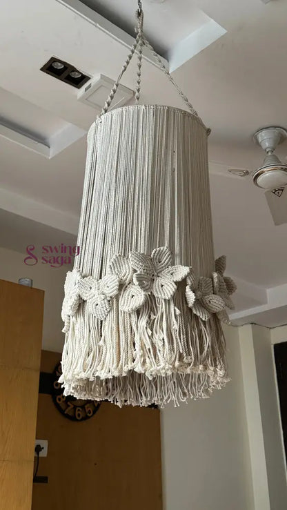 Decorative macrame cream chandelier with floral accents and circular hanging frame
