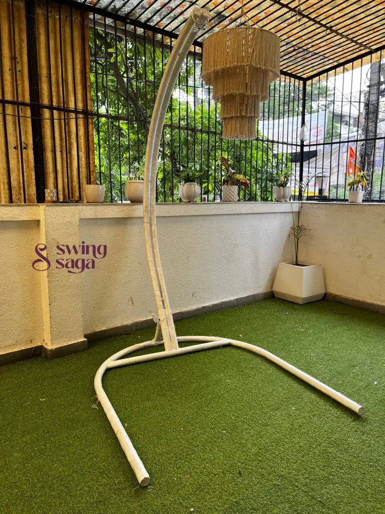 Metal white stand on a faux grass mat