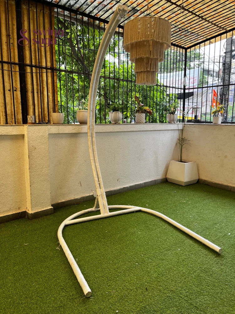 Metal white stand on a faux grass mat