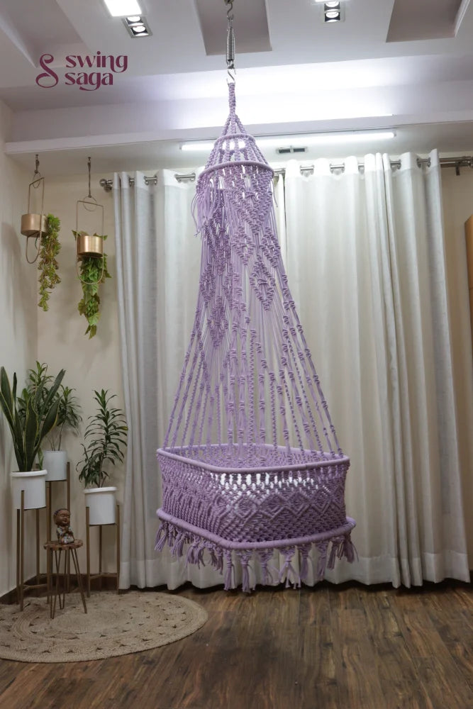 Lavender macrame cradle swing with white mattress for nursery or living room