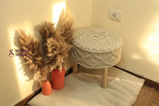 white macrame handcrafted ottoman with  terracotta vases