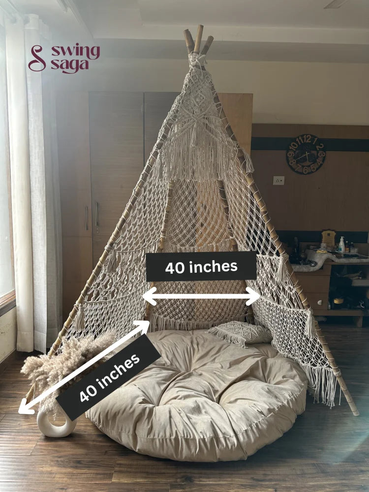 White macrame teepee with measurements placed on a wooden floor.