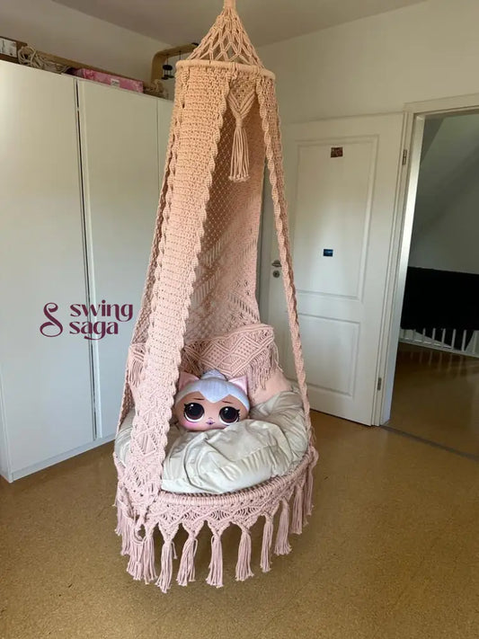 Macrame seater swing with two square shaped macrame cushions and one cartoon face cushion.