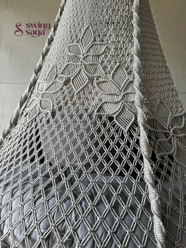 Intricate macrame knotting design on the Back of a grey macrame swing.
