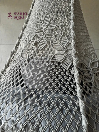 Intricate macrame knotting design on the Back of a grey macrame swing.
