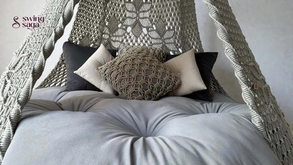 Macrame hanging swing in grey color with macrame cushions and square shaped cushions.