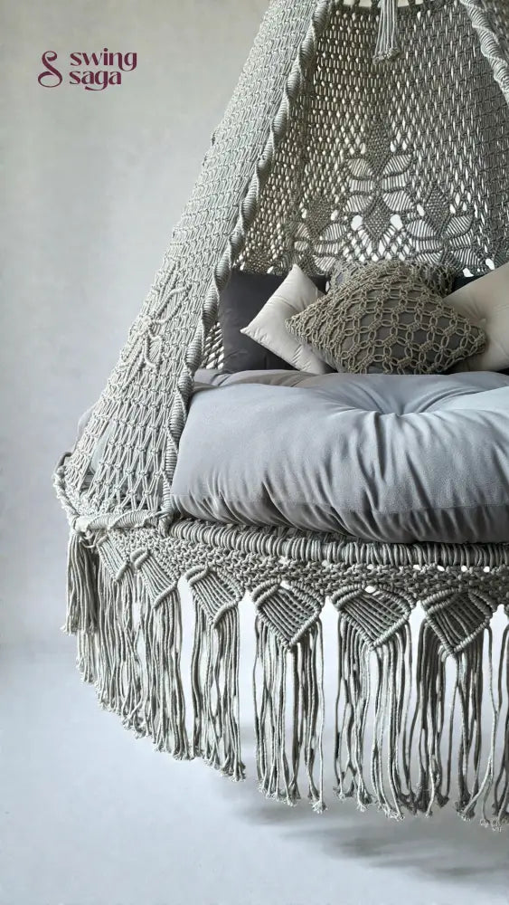Macrame grey bed swing in simple background.